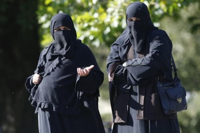 Women in full face veils walk in London's Regents Park (photo credit: REUTERS)