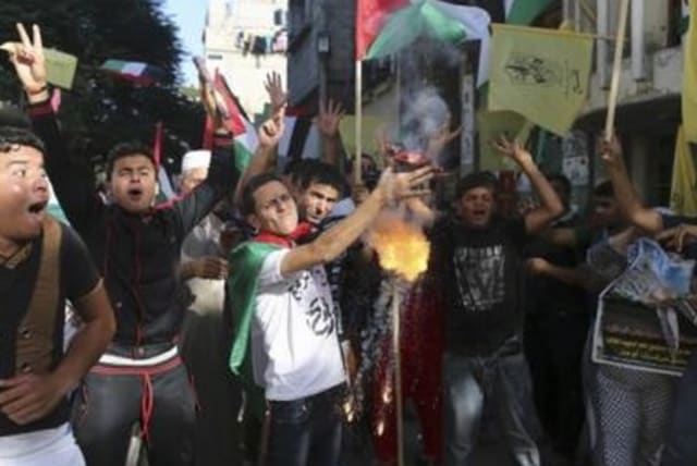 Palestinians celebrated the announcement of a Fatah-Hamas unity government, in the Gaza Strip June 2, 2014. (photo credit: REUTERS)