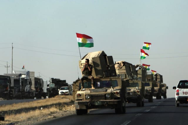 Kurdish Peshmerga vehicles rush to the front line at Altun Kupri after clashes with Iraqi security forces last Friday. (photo credit: REUTERS)