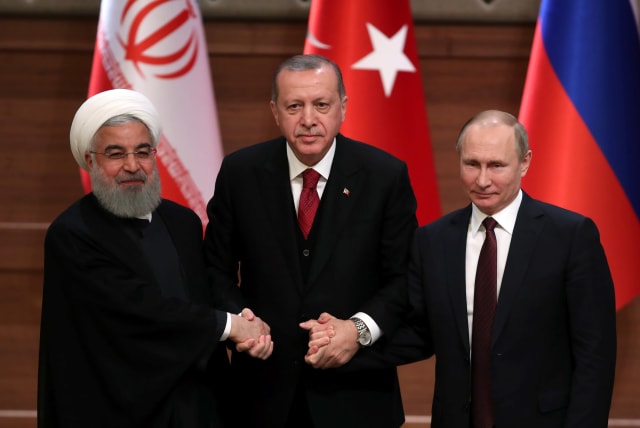 Presidents Hassan Rouhani of Iran, Tayyip Erdogan of Turkey and Vladimir Putin of Russia hold a joint news conference after their meeting in Ankara, Turkey April 4, 2018 (photo credit: UMIT BEKTAS / REUTERS)