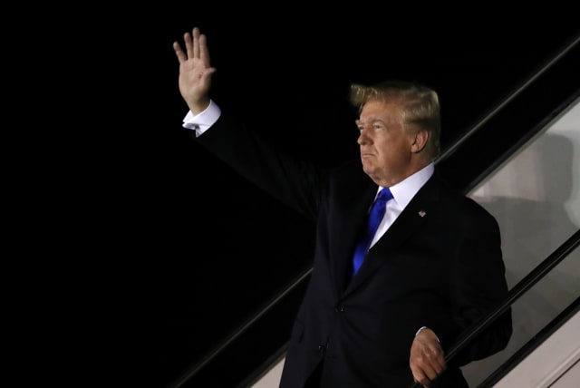 U.S. President Donald Trump waves as he disembarks Air Force One after arriving in Singapore June 10, 2018 (photo credit: JONATHAN ERNST / REUTERS)
