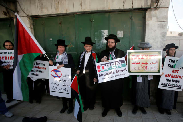 Members of Neturei Karta, a fringe ultra-Orthodox movement within the anti-Zionist bloc, attend a protest in solidarity with Palestinians in Hebron in February. (photo credit: MUSSA QAWASMA / REUTERS)