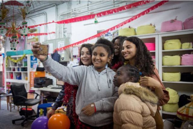 Sylvana Tsegai takes a selfie at the  Kuchinate, African Refugee Women’s Collective's Christmas party (photo credit: MIRIAM ALSTER)