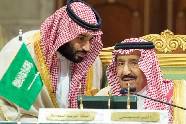 Saudi Arabia's Crown Prince Mohammed bin Salman talks with Saudi Arabia's King Salman bin Abdulaziz Al Saud during the Gulf Cooperation Council's (GCC) Summit in Riyadh, Saudi Arabia December 9, 2018 (photo credit: BANDAR ALGALOUD/COURTESY OF SAUDI ROYAL COURT/HANDOUT VIA REUTERS)