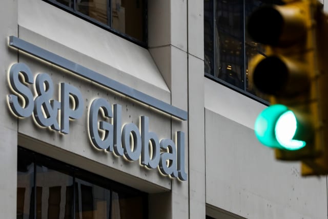 The S&P Global logo is displayed on its offices in the financial district in New York City (photo credit: BRENDAN MCDERMID/REUTERS)