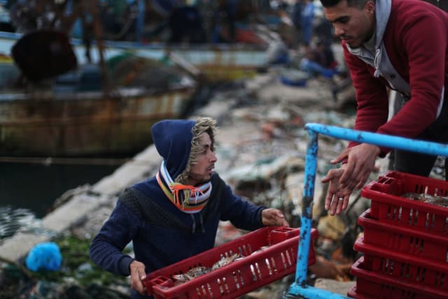Fishermen unload their catch at the seaport of Gaza City, after Israel expanded fishing zone for Palestinians April 2, 2019. (photo credit: SUHAIB SALEM / REUTERS)