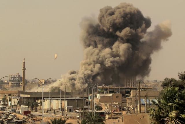 Smoke rises after an air strike during fighting between members of the Syrian Democratic Forces and Islamic State militants in Raqqa, Syria (photo credit: REUTERS/ZOHRA BENSEMRA)