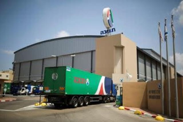 A Tnuva truck enters the company's logistic centre in the southern town of Kiryat Malachi, Israel May 22, 2014.  (photo credit: REUTERS/AMIR COHEN/FILE PHOTO)