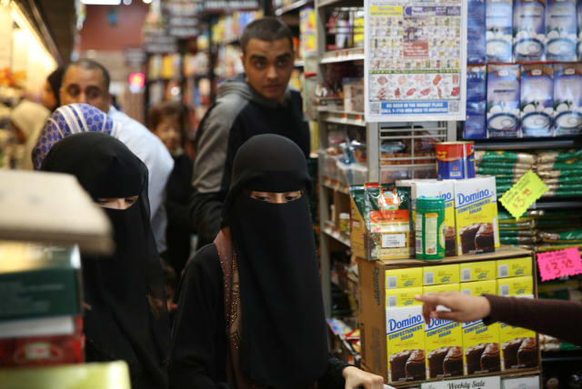 Muslim American women wearing hijab shop at the Balady halal supermarket ahead of the first day of Ramadan in Brooklyn, New York (photo credit: REUTERS)