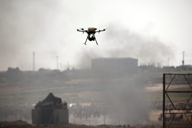 A drone is seen over the border between Israel and Gaza in June (photo credit: AMIR COHEN/REUTERS)