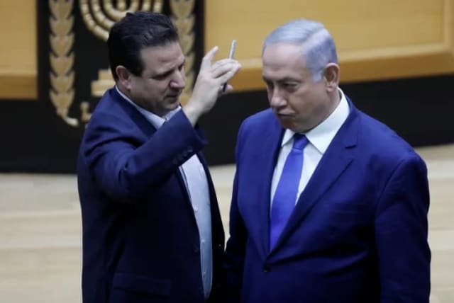 MK Ayman Odeh places camera in PM Benjamin Netanyahu's face during debate on bill legislating filming in polling stations (photo credit: ISAAC HARARI / KNESSET SPOKESPERSON'S OFFICE)