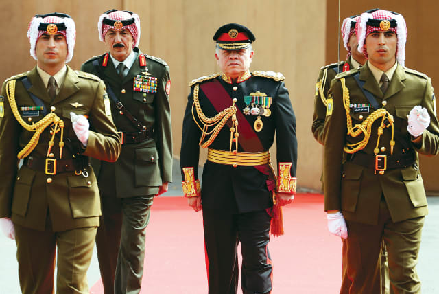 JORDAN’S KING Abdullah reviews the honour guard before the opening of the second ordinary session of 17th Session of Parliament in Amman IN 2014.  (photo credit: REUTERS)
