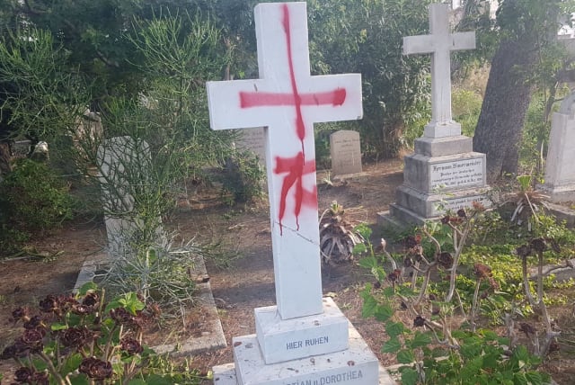 Tombstones desecrated with graffiti at the British cemetery in Haifa (photo credit: POLICE SPOKESPERSON'S UNIT)