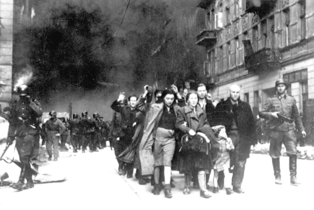 Captured Jews pulled out of Warsaw Ghetto bunkers are led by German Waffen SS soldiers to 'Umschlagplatz,' the assembly point for deportation.  (photo credit: Wikimedia Commons)