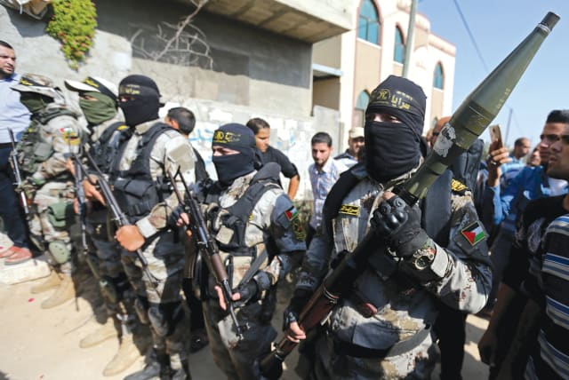 ISLAMIC JIHAD terrorists show off their weapons in the Gaza Strip.  (photo credit: REUTERS)
