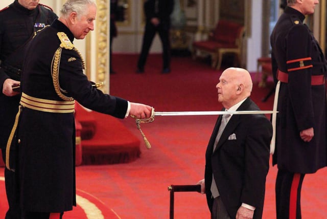 Ben Helfgott is knighted by Prince Charles at Buckingham Palace (photo credit: Courtesy)