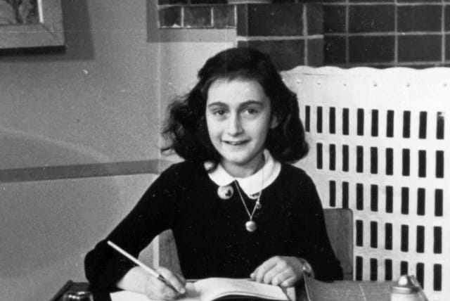 Anne Frank at her writing table in 1940; how many Anne Franks were lost in the Holocaust? (photo credit: Wikimedia Commons)