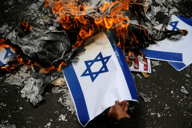 Israeli flag being burned. (photo credit: BEAWIHARTA BEAWIHARTA/ REUTERS)