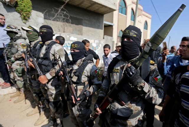 Palestinian Islamic Jihad militants take part in the funeral of their comrade in the southern Gaza Strip November 14, 2019 (photo credit: REUTERS/IBRAHEEM ABU MUSTAFA)