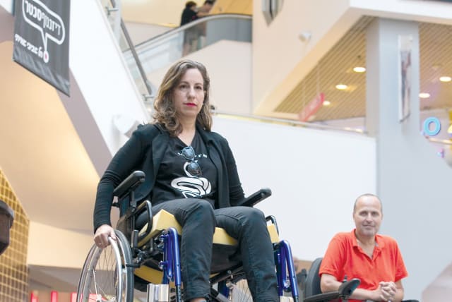 THE WRITER learns firsthand how those who are disabled and confined to a wheelchair function in everyday life, accompanied by Ophir Eytan (photo credit: YOSSI ALONI)