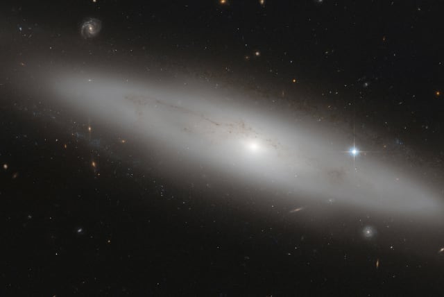 NGC 4866, a lenticular galaxy, is shown in this NASA handout provided on July 19, 2013. Situated about 80 million light-years from earth, this image was captured by the Advanced Camera for Surveys, an instrument on the NASA/ESA Hubble Space Telescope (photo credit: REUTERS/EUROPEAN SPACE AGENCY/NASA/ESA HUBBLE SPACE TELESCOPE/HANDOUT VIA REUTERS)