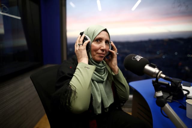Iman Yassin Khatib, poised to become the first lawmaker in Israel's history to wear a hijab or head scarf, which she does as a Muslim, following results of her Arab Joint List party in Israel's election, participates in an interview in a radio show in Naz (photo credit: REUTERS)