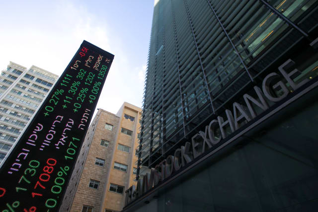 An electronic board displaying market data is seen at the entrance of the Tel Aviv Stock Exchange, in Tel Aviv, Israel (photo credit: REUTERS)