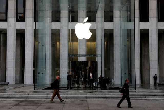 FILE PHOTO: The Apple Inc. logo is seen hanging at the entrance to the Apple store on 5th Avenue in Manhattan, New York, U.S., October 16, 2019 (photo credit: REUTERS/MIKE SEGAR/FILE PHOTO)