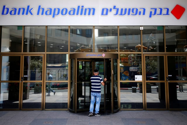 A man enters the main branch of Bank Hapoalim, Israel's biggest bank, in Tel Aviv, Israel July 18, 2016. (photo credit: AMIR COHEN/REUTERS)