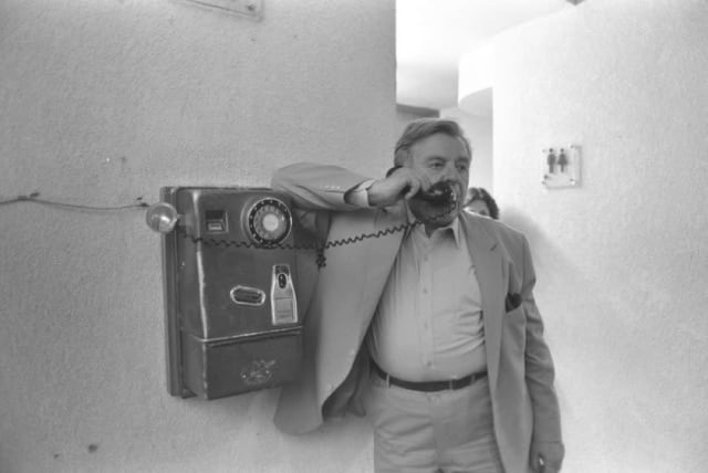 The late Teddy Kollek, mythical Mayor of Jerusalem, talks on a public phone (photo credit: NATI HARNIK/GPO)