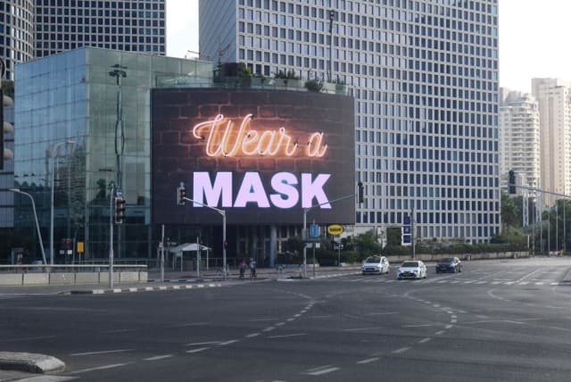 A sign pictured in Tel Aviv reads 'Wear a Mask' during Israel's second lockdown, September 2020. (photo credit: AVSHALOM SASSONI/ MAARIV)