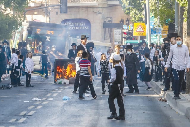 HAREDIM BURN garbage and protest enforcement of coronavirus restrictions in Mea She’arim earlier this week.  (photo credit: MARC ISRAEL SELLEM/THE JERUSALEM POST)