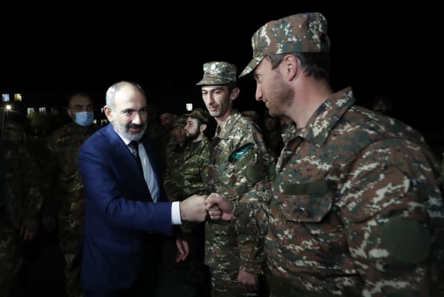 Armenian Prime Minister Nikol Pashinyan greets reservists at the Defence Ministry's base before their departure for the breakaway region of Nagorno-Karabakh in Yerevan, Armenia, October 16, 2020. (photo credit: ARMENIAN PRIME MINISTER PRESS SERVICE/TIGRAN MEHRABYAN/PAN PHOTO VIA REUTERS)