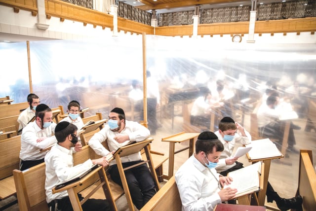 STUDENTS STUDY in separation compartments at the Kamenitz Yeshiva in Jerusalem in September to prevent the spread of COVID-19. (photo credit: YONATAN SINDEL/FLASH 90)