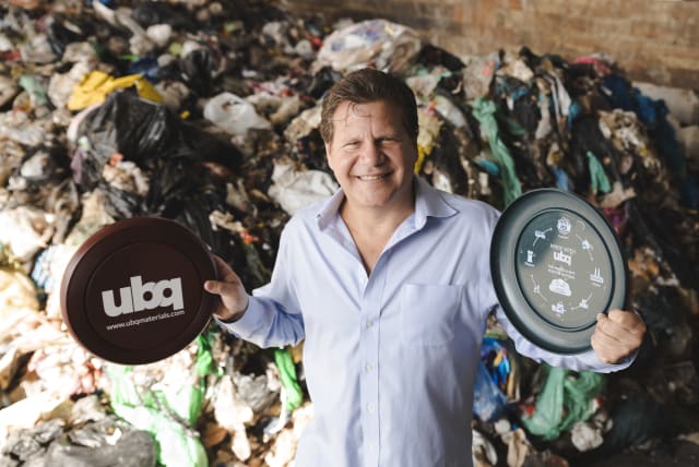 Jack (Tato) Bigio, UBQ Materials co-founder and CEO of UBQ Israel, holds plastic discs made from UBQ material. (photo credit: Courtesy)
