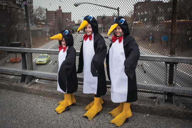 GIRL OR penguin? in costume on an overpass on Purim in South Williamsburg, New York, 2014. (photo credit: ANDREW KELLY / REUTERS)