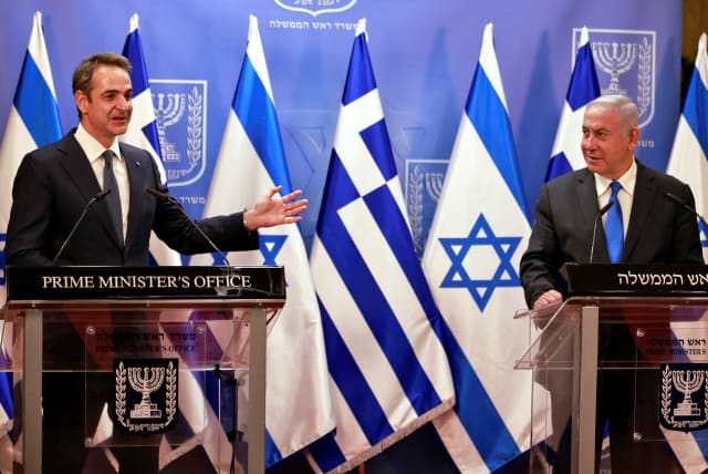 Greek Prime Minister Kyriakos Mitsotakis speaks next to the Israeli Prime Minister Benjamin Netanyahu after their meeting in the PM's office in Jerusalem February 8, 2021. (photo credit: MENAHEM KAHANA/POOL VIA REUTERS)