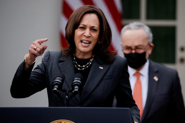 US Vice President Kamala Harris speaks about the $1.9 trillion "American Rescue Plan Act" as Senate Majority Leader Chuck Schumer (D-NY) listens during an event to celebrate the legislation in the Rose Garden at the White House in Washington, US, March 12, 2021.  (photo credit: REUTERS/TOM BRENNER)