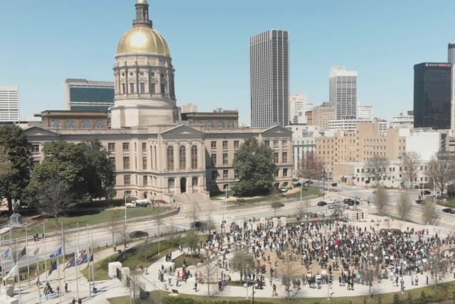 People participate in a Stop Asian Hate rally at Liberty Plaza, next to the Georgia State Capitol, in Atlanta, Georgia, March 20, 2021, in this still image from drone video obtained via social media. (photo credit: ARRHYTHMIA FILMS VIA REUTERS)