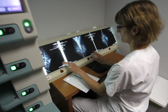 A radiologist examines breast X-rays after a cancer prevention medical check-up at the Ambroise Pare hospital in Marseille (photo credit: JEAN-PAUL PELISSIER / REUTERS)