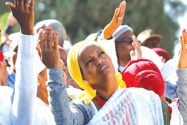 AN ISRAELI ETHIOPIAN woman prays during a ceremony marking the holiday of Sigd, in Jerusalem in 2019. (photo credit: CORINNA KERN/REUTERS)