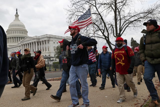 Members of the Proud Boys and supporters of US President Donald Trump show up at the US Capitol Building over an hour before supporters began to storm the building in Washington, US, January 6, 2021. (photo credit: REUTERS/LEAH MILLIS)