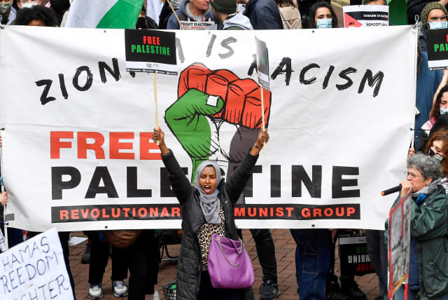 Pro-Palestinian demonstrators attend a protest following a flare-up of Israeli-Palestinian violence, in London, Britain May 22, 2021. (photo credit: TOBY MELVILLE/REUTERS)