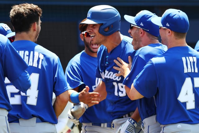 Danny Valencia of Israel celebrates his 3-run home run with teammates, during Israel's 12-5 win over Mexico on August 1st, 2021  (photo credit: JORGE SILVA / REUTERS)