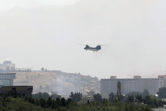  A CH-46 Sea Knight military transport helicopter flies over Kabul, Afghanistan this week. (photo credit: STRINGER/ REUTERS)