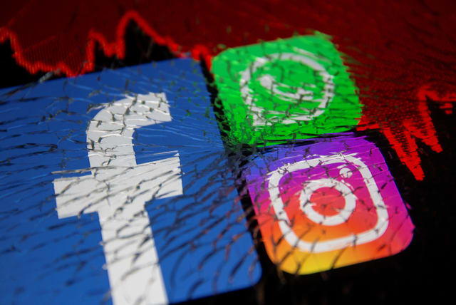  Facebook, Whatsapp and Instagram logos and stock graph are displayed through broken glass in this illustration taken October 4, 2021.  (photo credit: REUTERS/DADO RUVIC)