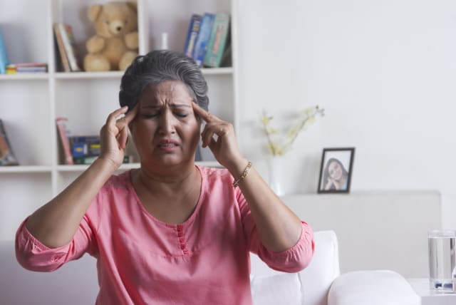  Woman with a headache (photo credit: INGIMAGE)