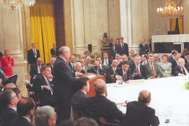 THEN-SOVIET PRESIDENT Mikhail Gorbachev addresses the first meeting of the Mideast peace conference in Madrid on October 30, 1991. Alongside Gorbachev is US President George Bush. At far right is prime minister Yitzhak Shamir. (photo credit: JIM HOLLANDER/REUTERS)
