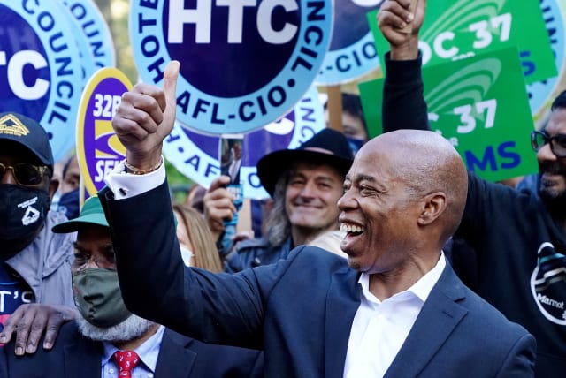 Democratic candidate for New York City Mayor Eric Adams attends a rally at City Hall the day before the election in the Manhattan borough of New York City, New York, U.S., November 1, 2021.  (photo credit: REUTERS/CARLO ALLEGRI)