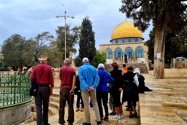  A group Israeli tourists begin their visit to Al-Aqsa/Temple Mount on October 31, 2021; the iconic Dome of the Rock shrine is seen ahead.